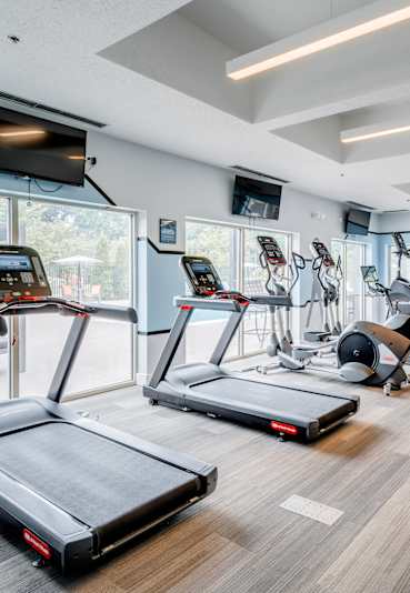 A gym with treadmills, exercise equipment, and a sign that says "POWER".