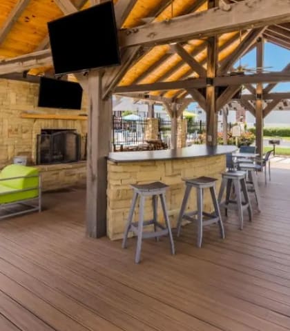 a patio with a bar and chairs and tables at Reserve of Bossier City Apartment Homes, Bossier City, Louisiana