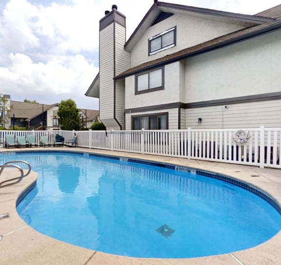 a swimming pool in front of a house