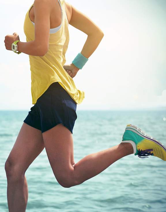 A woman running on the beach.