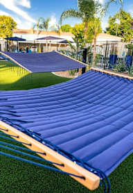 A blue inflatable slide in a backyard at Nola 624 Apartments, West Covina, CA, 91790