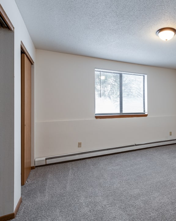 the living room of an empty house with a window