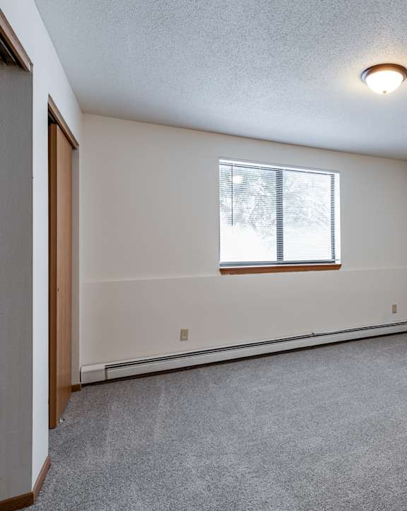 the living room of an empty house with a window at Autumn Hills Apartments, Forest Lake, MN, 55025