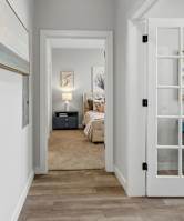 a hallway with a bedroom at the end