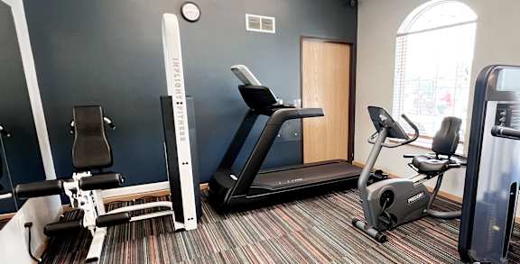 a variety of exercise equipment in the fitness center