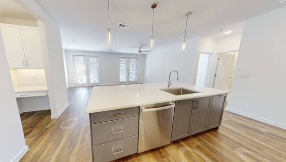 A modern kitchen with wooden floors and white walls.