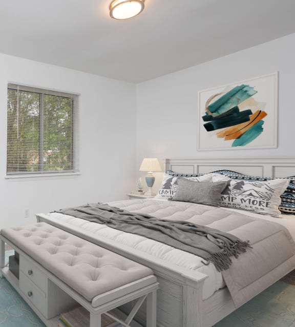 a bedroom with a bed and a kitchen and a living room