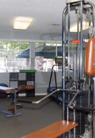 a gym with a lot of exercise equipment in a room