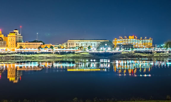 the downtown skyline at night with the river