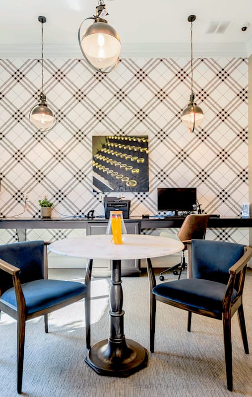 A dining room with a table and chairs.