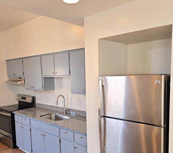 A stainless steel range hood is installed in a kitchen.
