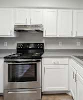 a kitchen with white cabinets and stainless steel appliances at Vista Linda, Santa Fe, 87507