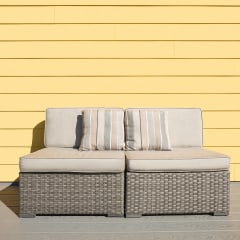 a white couch and a table in front of a yellow wall