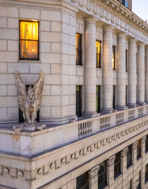 a large building with a statue of an angel on the side of it
