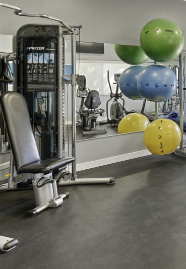 a gym with cardio equipment and weights  at Camelot Apartment Homes, Everett, WA, 98204