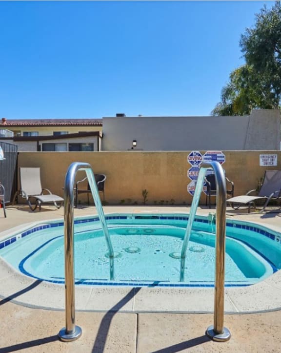 our apartments have a hot tub and a patio with chairs at Huntington Terrace North Senior, California, 92648