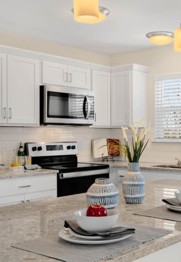 a kitchen with a counter top and a sink at Mainstreet Village, Novi, MI, 48375