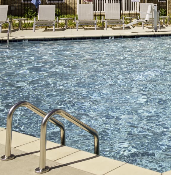 a swimming pool in front of an apartment building