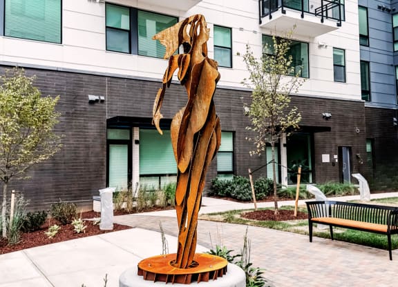 a statue of a woman in the courtyard of a building at Makers Rise, Virginia  