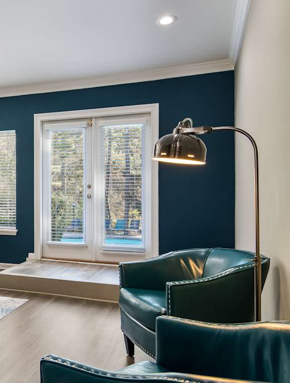 A dining room with a table set for four.