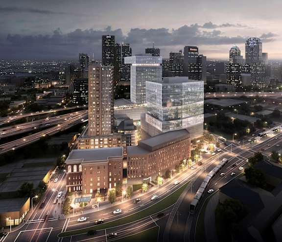 an aerial view of a city at night with highways and buildings