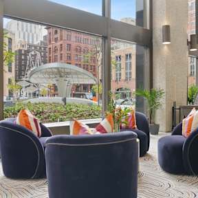 A large room with a table and chairs and a view of the city.