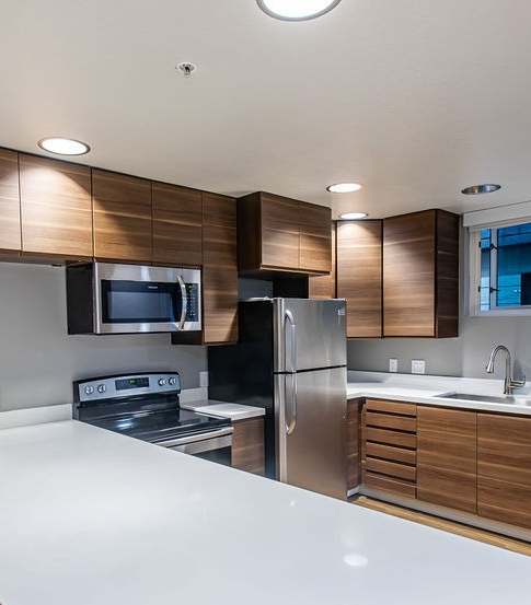 A room with a desk, chair, and shelves with various items on them.