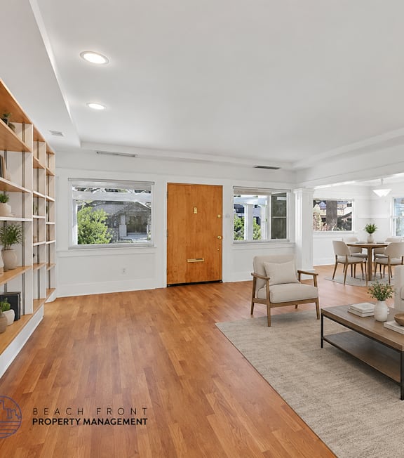 A well-lit, modern kitchen and living room with a dining area.