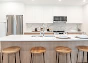 Thumbnail 7 of 7 - Kitchen with a White Countertop at Woodland Place Apartments, British Columbia