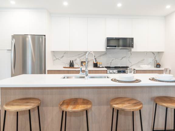 Kitchen with a White Countertop at Woodland Place Apartments, British Columbia