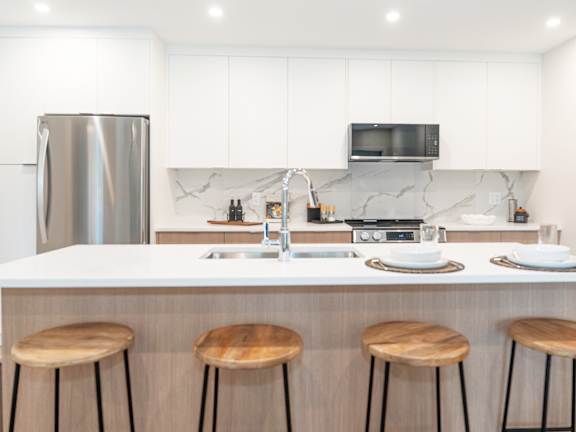 Kitchen with a White Countertop at Woodland Place Apartments, British Columbia