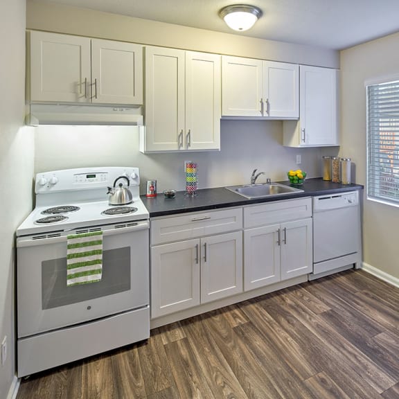 white kitchen with wood style flooring and appliances