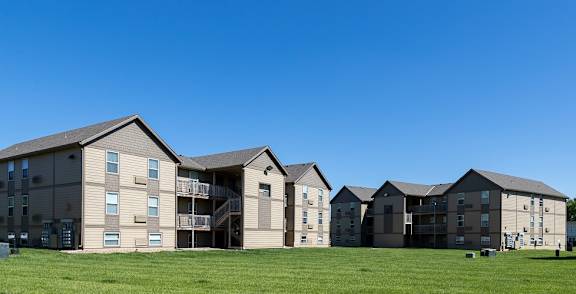 The exterior of Bavarian Village Apartments with well-kept landscaping.
