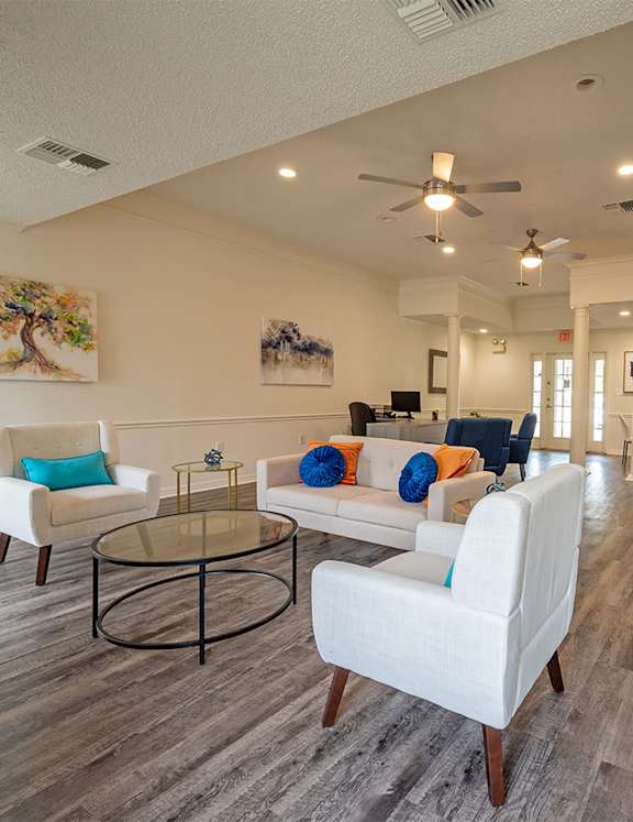 A living room with a fireplace and a dining table.