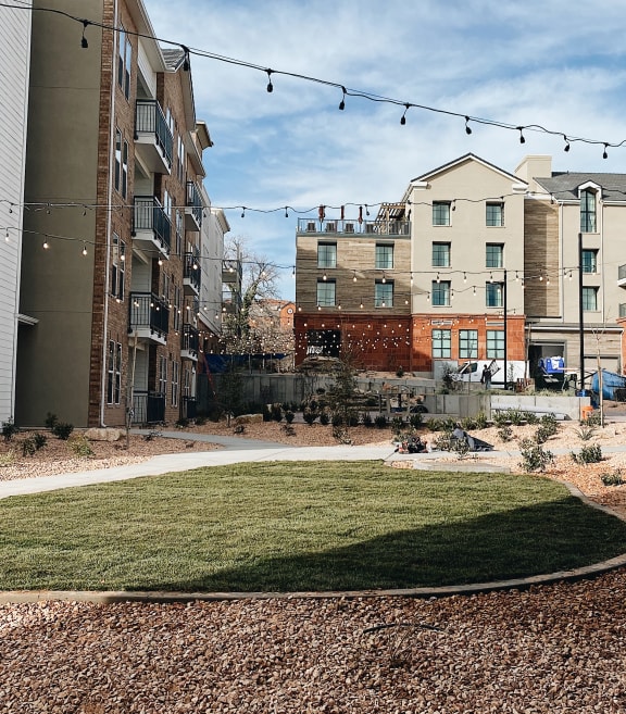 a grassy area with buildings in the background at City View St. George Apartments, Utah, 84770