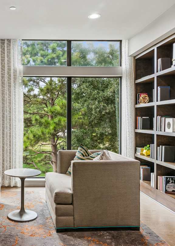 A living room with two couches and a table in front of a large window.