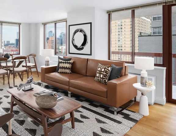 A living room with a brown couch and a coffee table. at The Ellington Apartments, New York