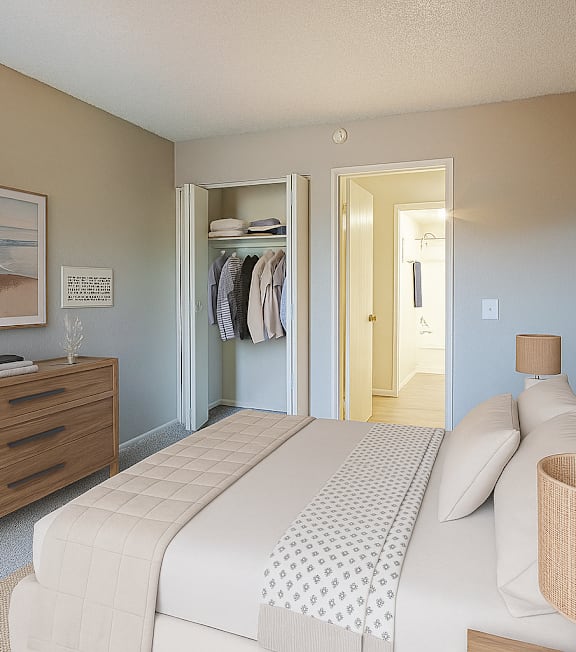 A bedroom with a large bed, a dresser, and a wardrobe.