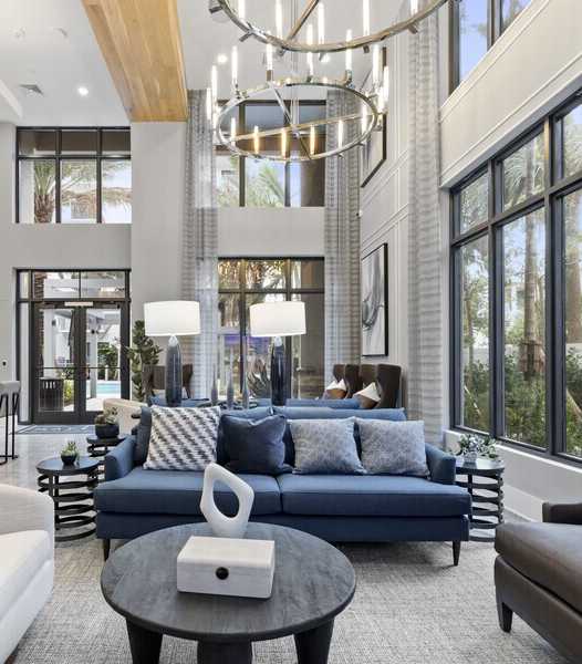 A modern outdoor dining area with a television mounted on the wall.