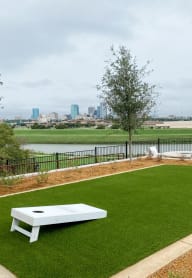 Presidio at River East Apartments Cornhole Court and Downtown Skyline of Fort Worth, Texas in Background