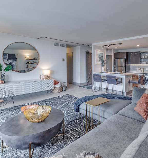 A modern living room with a grey sofa and a round coffee table.
