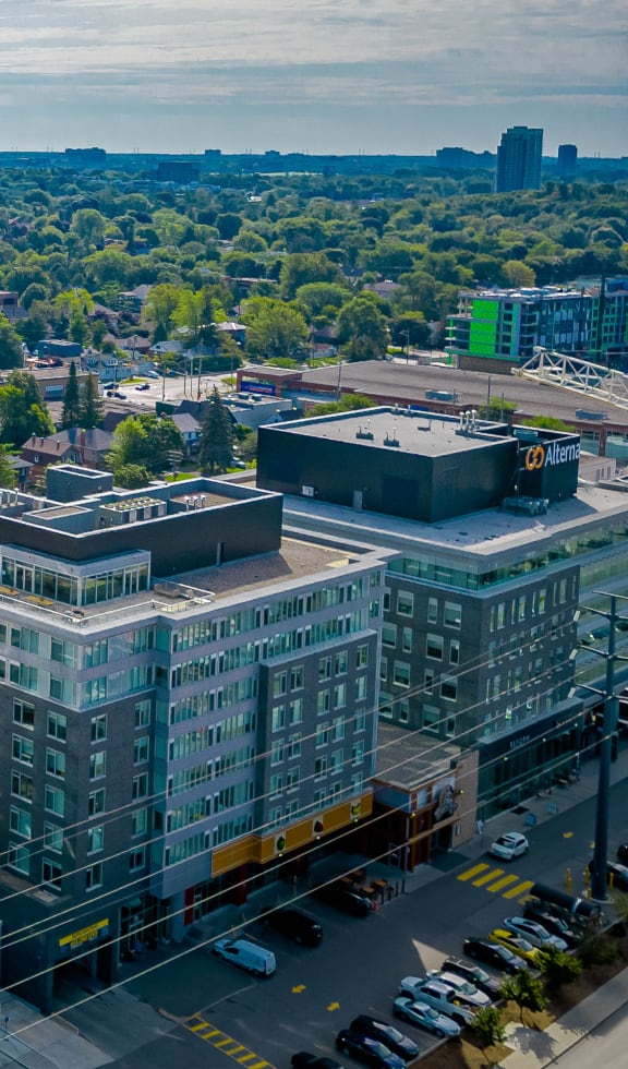 an aerial view of a tall building in a city