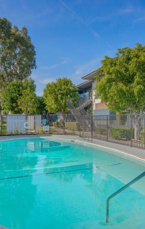 a swimming pool in front of an apartment building with a pool at BLVD Apartments LLC, Tarzana, CA