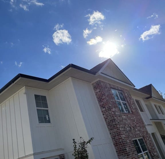the exterior of a house with the sun shining in the sky