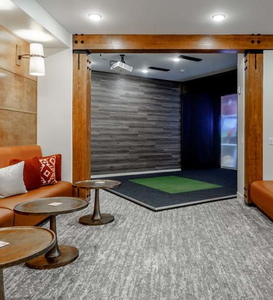 a living room with orange couches and a tv