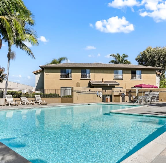 a swimming pool at the resort with palm trees