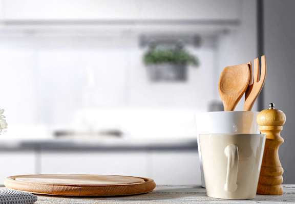 a kitchen table with a coffee cup and utensils on it