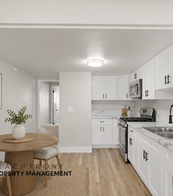 A well-lit, modern kitchen and living room with a dining area.