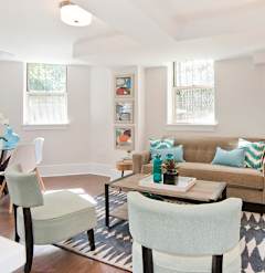 a living room with a couch and a table and chairs