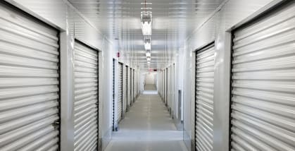 A long hallway with closed silver doors on both sides.